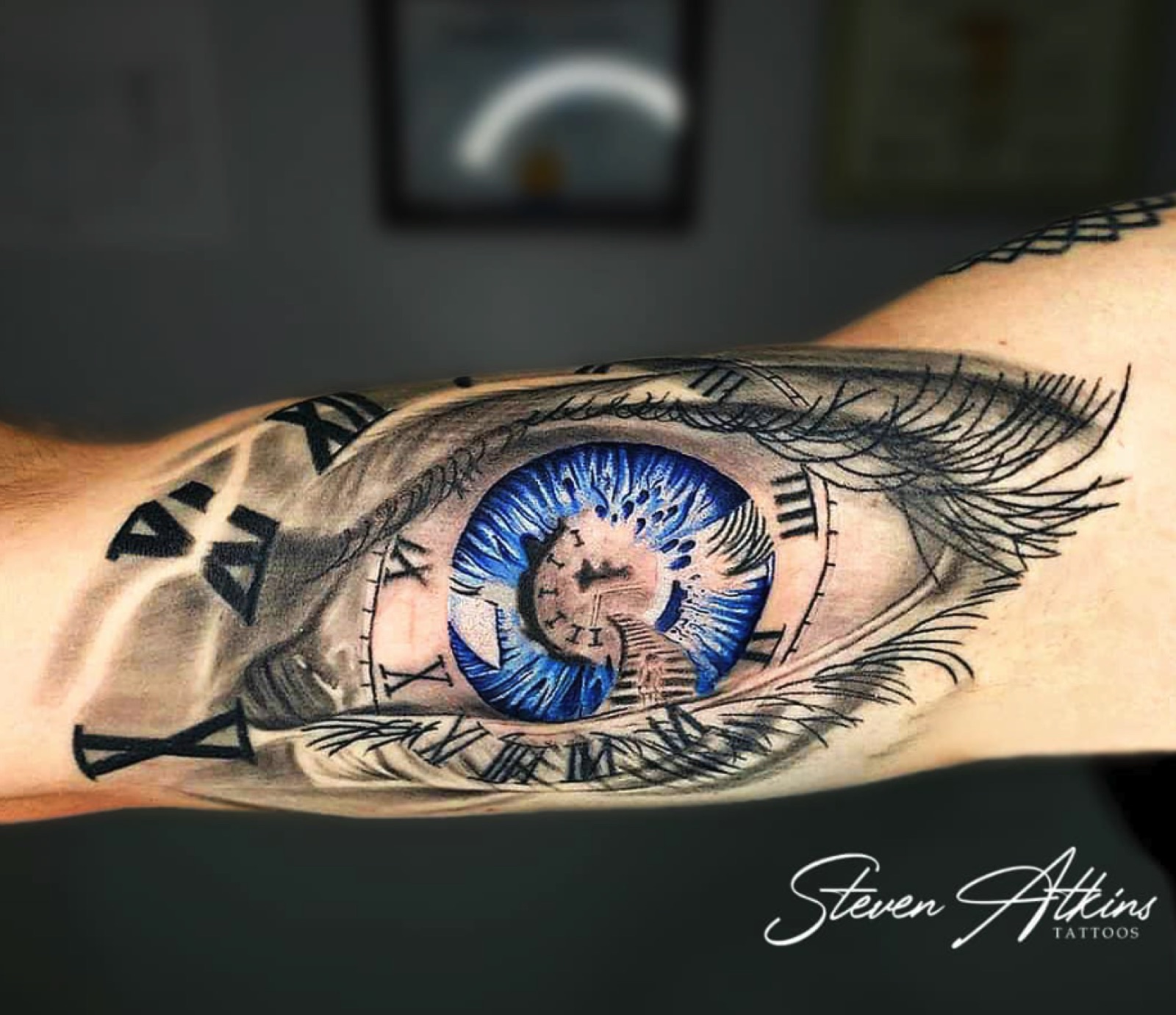 Realistic eye and clock forearm tattoo